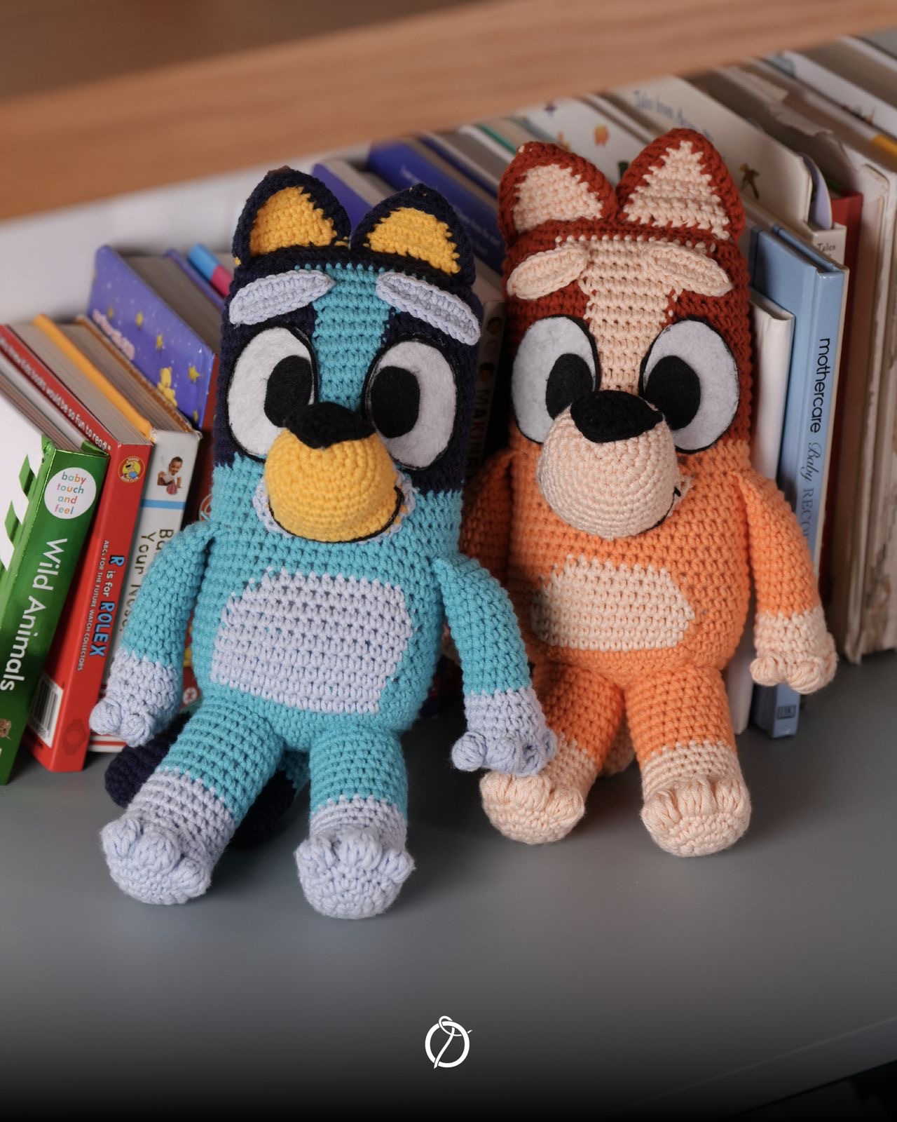Handmade crochet Bluey and Bingo dolls sitting side by side