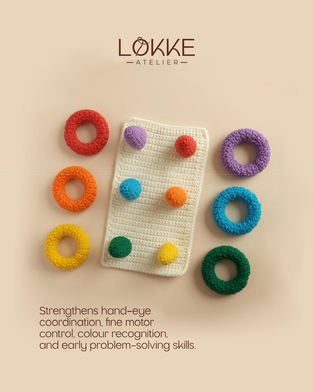 Cream crochet board with six coloured pegs and matching rings