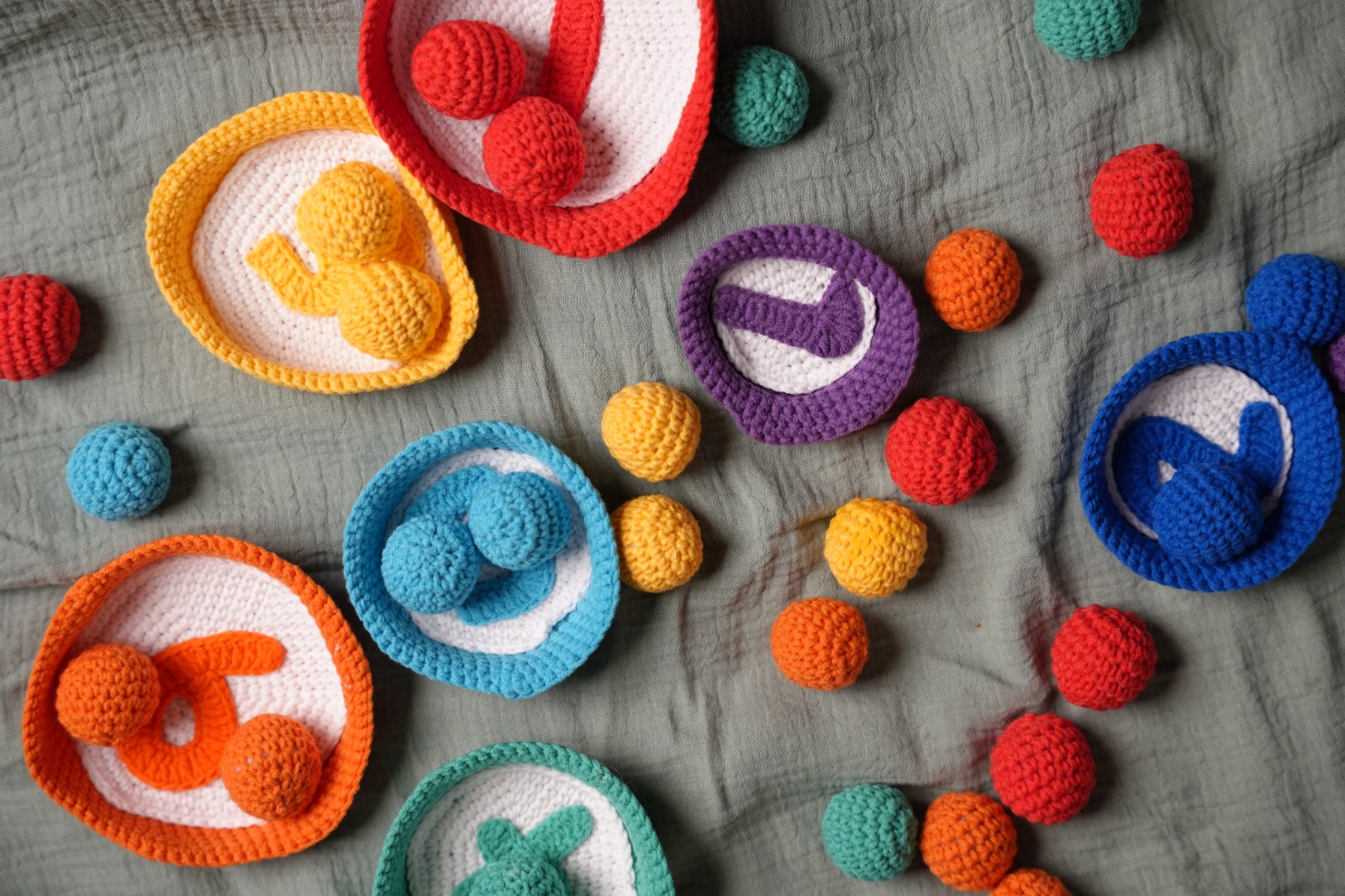 Close-up of crochet count-and-sort bowls with numbered centres