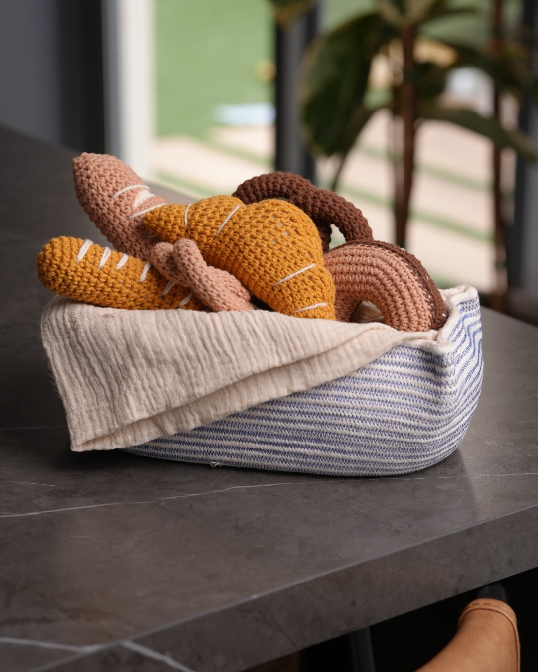 Crochet croissants, pretzel, and breads in a play bakery basket