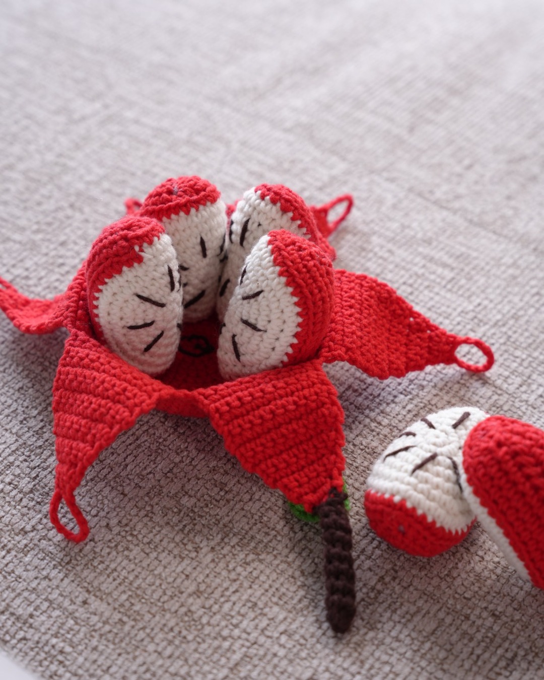 Peelable crochet apple opened to show white wedges